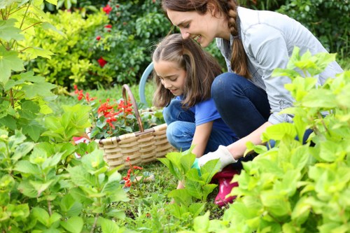 Operatives performing garden maintenance with safety equipment